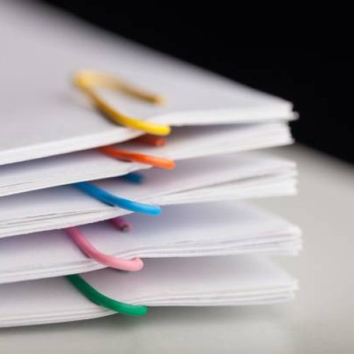 File folders with documents and bright paperclips
